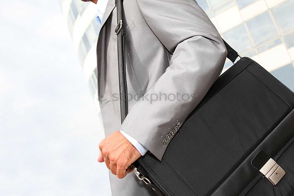 one person holds a leather travel bag in his hand