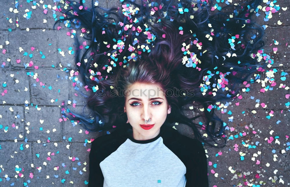Young redhead woman and a blue tree