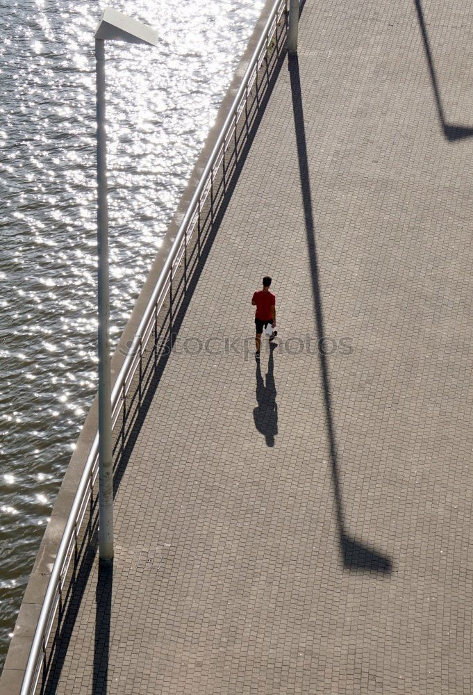 Similar – Image, Stock Photo elegantly dressed lady with black coat, red hat, red scarf and red pumps walks on a large square with concrete and patterned floor