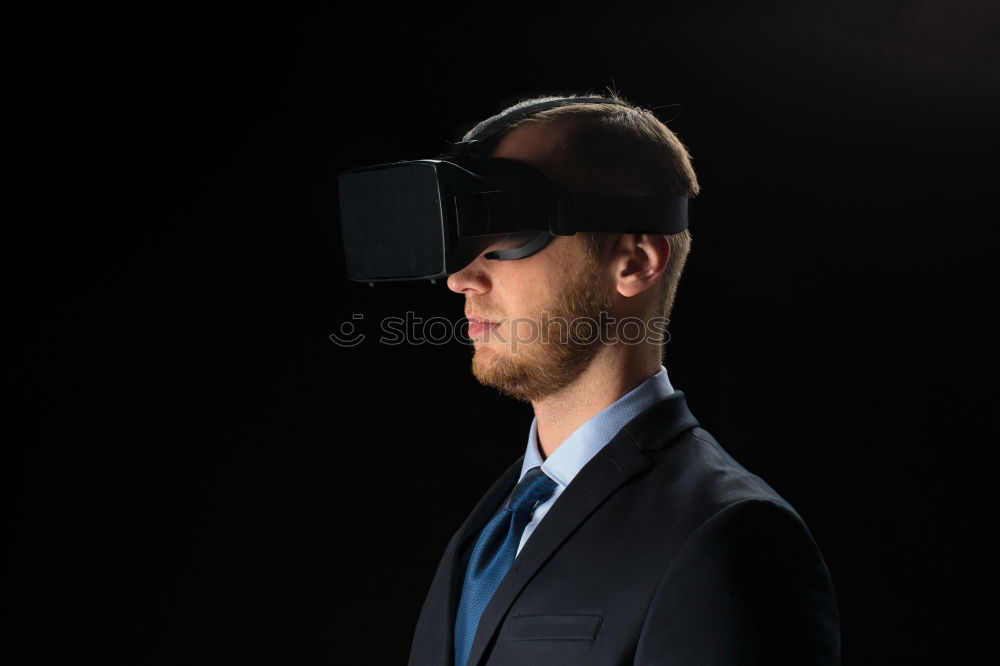 Similar – Bearded man dressed in blue t-shirt with binoculars posing against black background