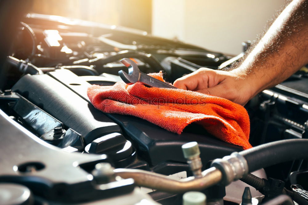 Similar – Professional Mechanic Repairing Car.