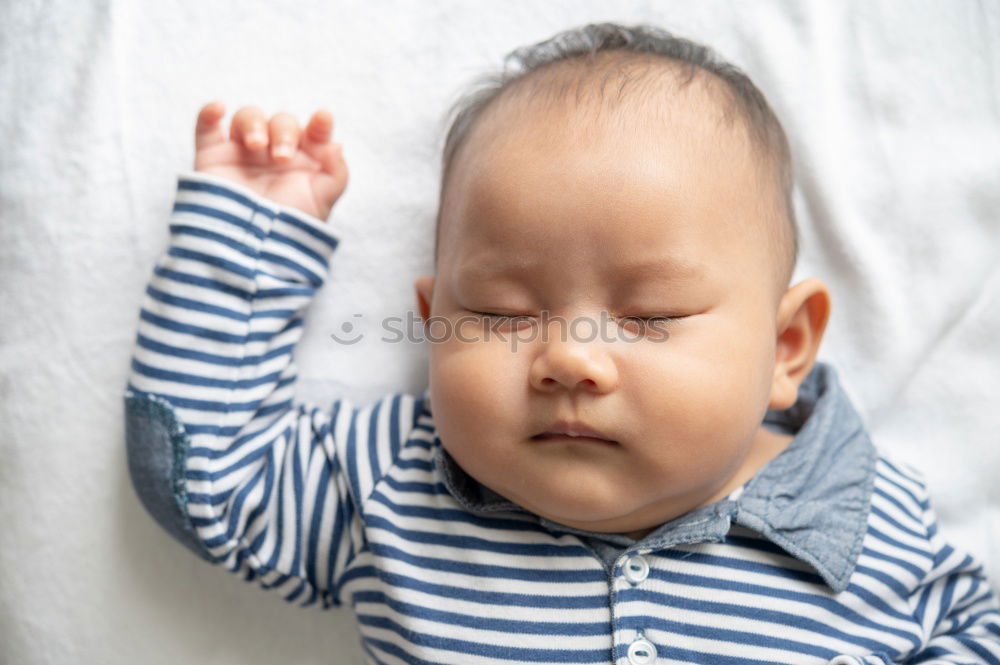 Similar – The back of a baby’s head lying on its stomach