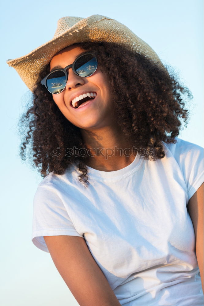 Young black woman, afro hairstyle, smiling.