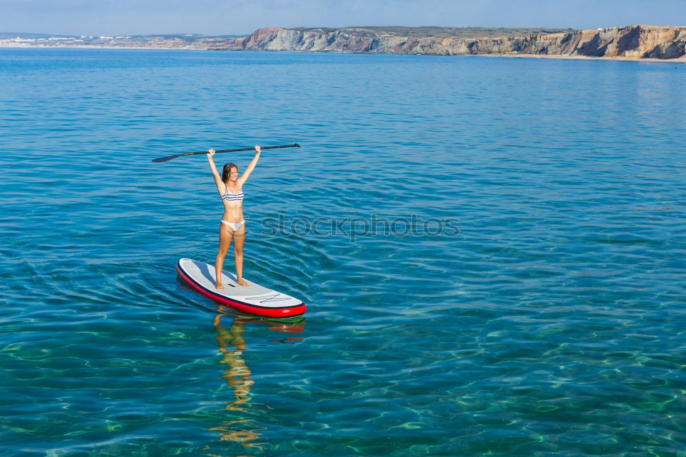 Similar – Little boy floating on the sea with transparent water