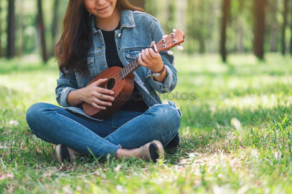 Similar – Beautiful woman playing guitar.