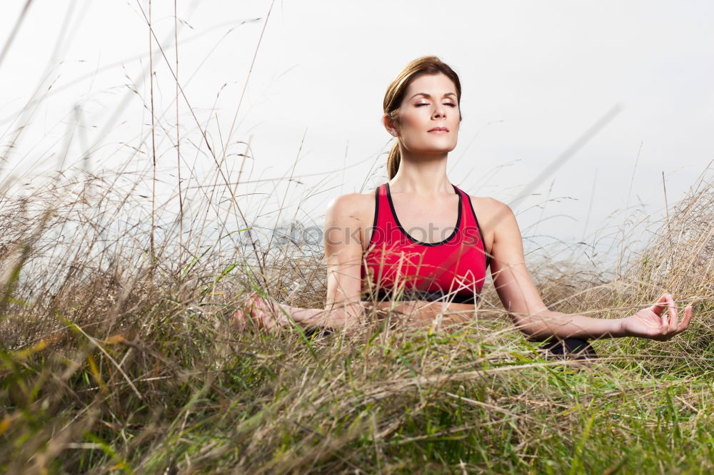 Similar – Young woman doing yoga in nature.