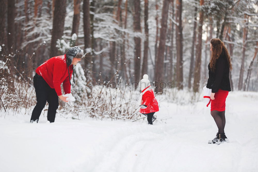 Similar – Teenage girl enjoying snow with her little sister. Children are walking through deep snow while snow falling, enjoying wintertime. Sisters spending time together. Girls are wearing winter clothes, young girl is wearing pink coat and wool cap