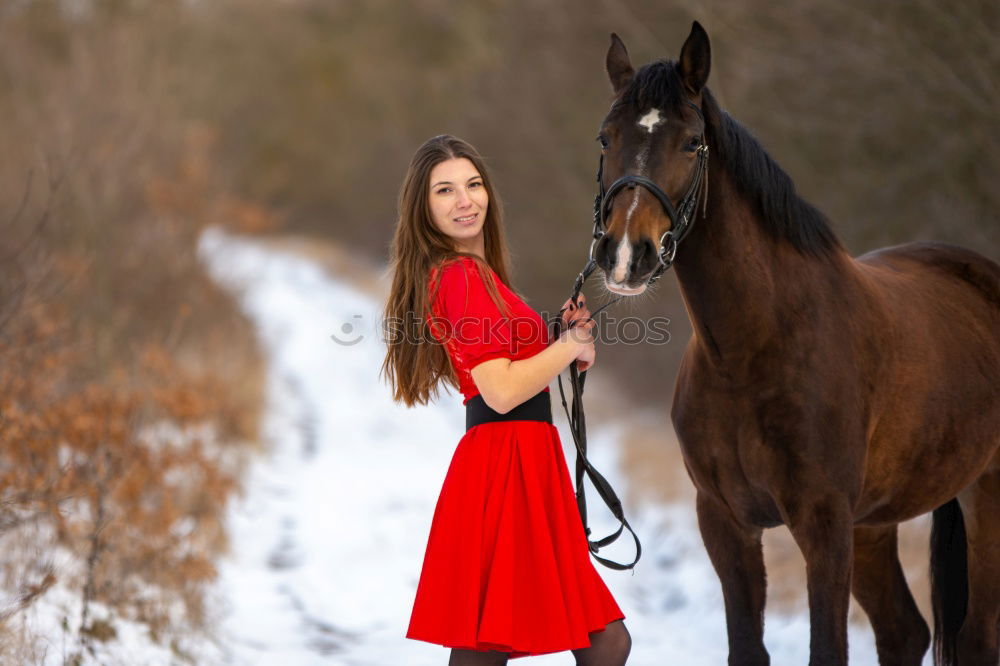 Similar – Young dark-haired curly woman with horse in stable