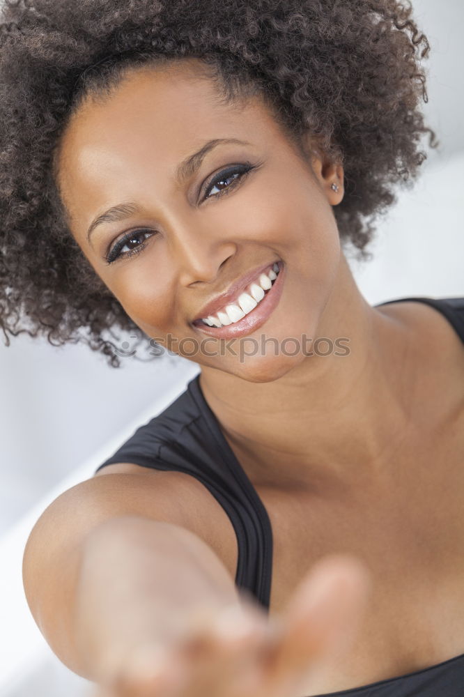 Similar – Black woman with afro hairstyle smiling in urban park.