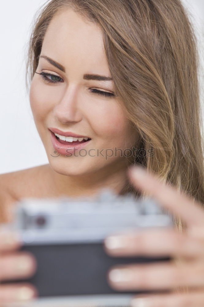 Young blonde girl with her mobile phone