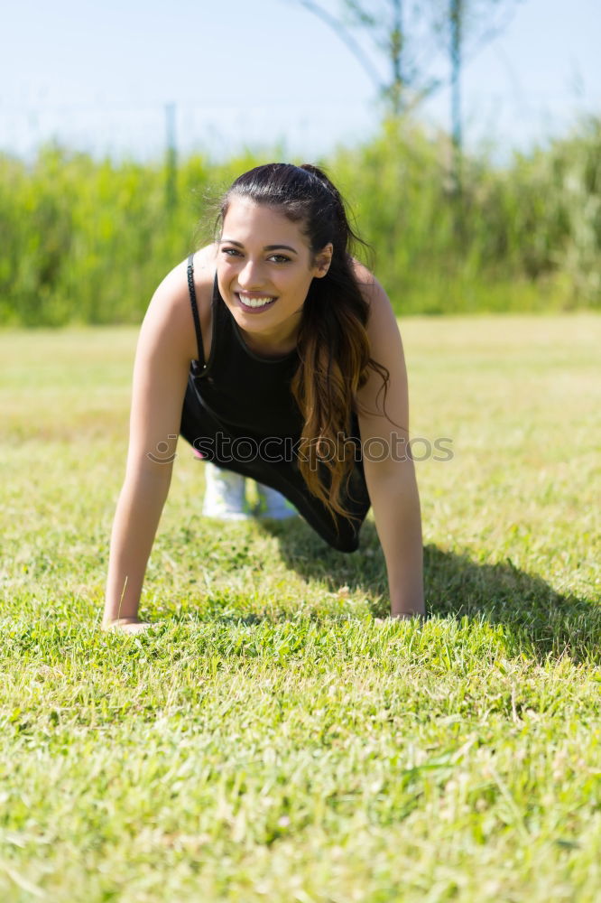 Similar – Athletic young woman doing push up exercises