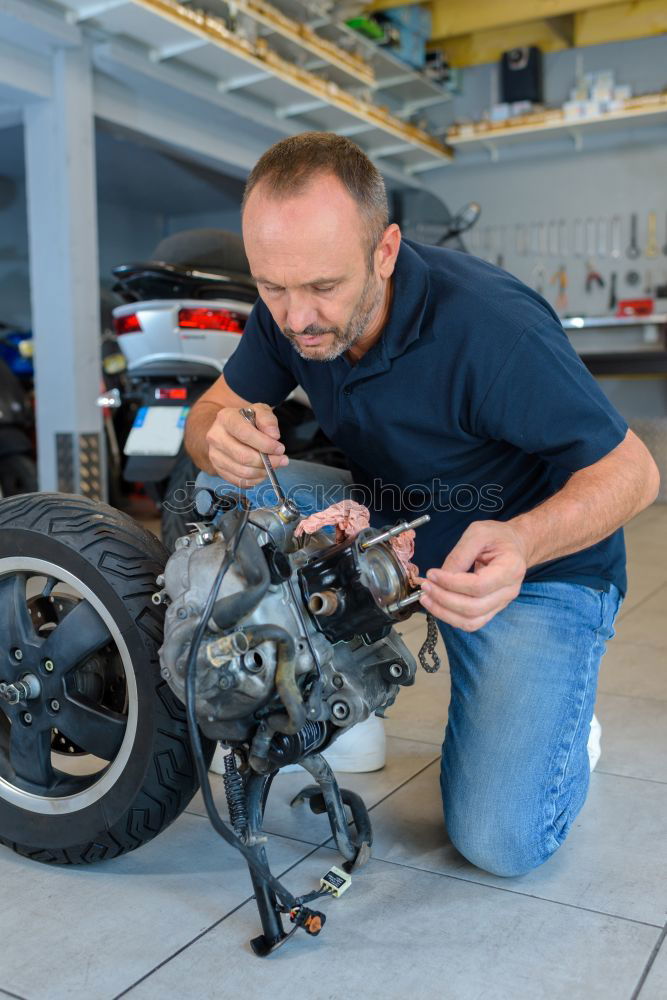 Similar – Image, Stock Photo Mechanic checking motorcycle