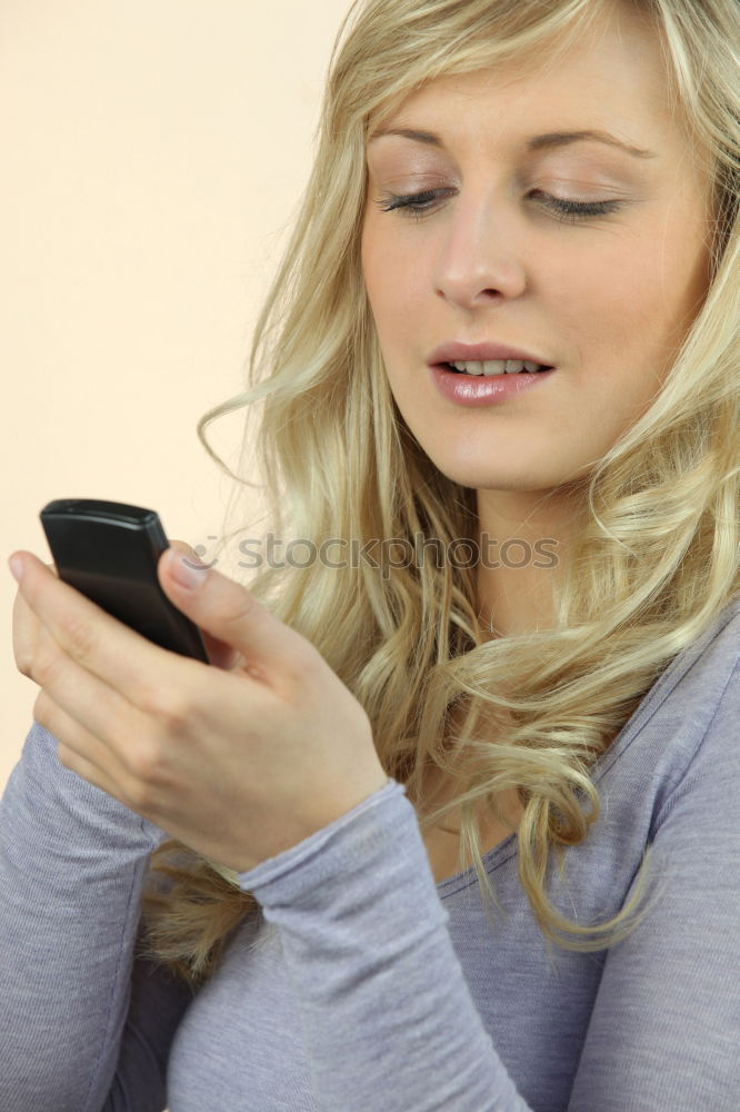 Similar – Young woman texting with a smartphone outdoors