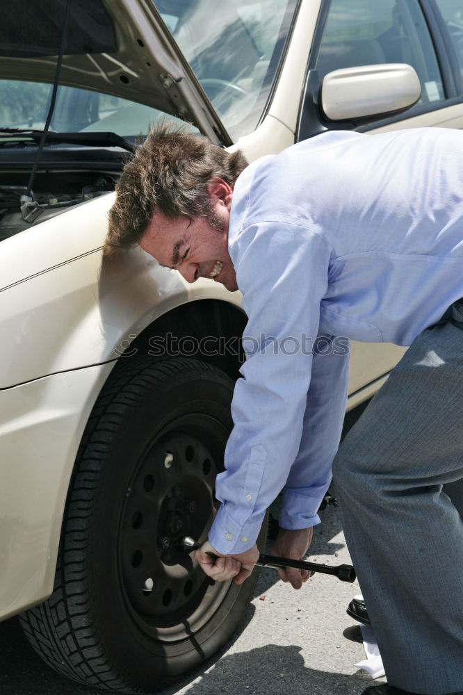 Similar – Professional Mechanic Repairing Car.