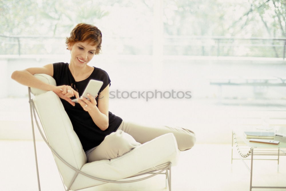 Similar – Smiling businesswoman with magazine and crossed legs sitting chair against of modern wall