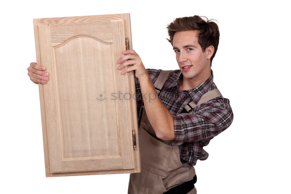 Similar – Young man looks curiously over a barrier