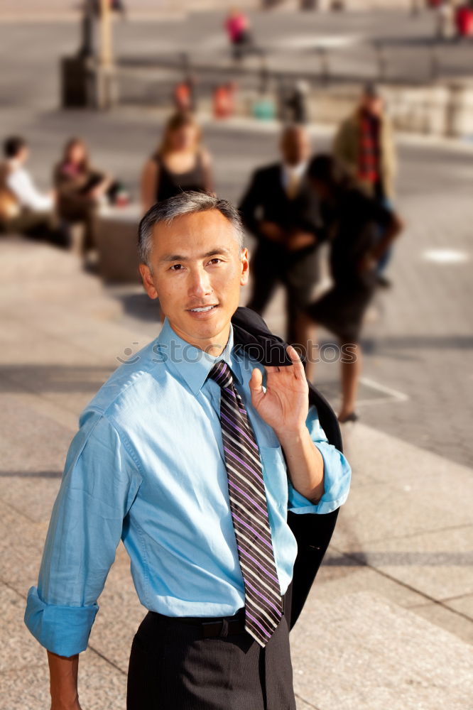 Handsome businessman walking in an urban street