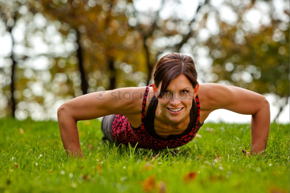 Similar – Athletic young woman doing push up exercises