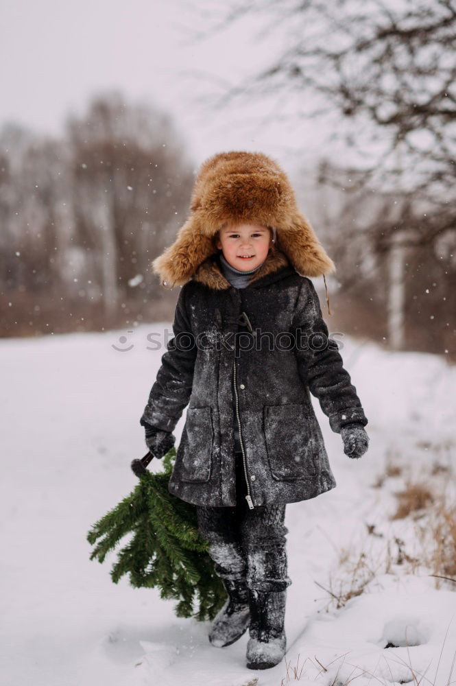 Similar – Image, Stock Photo Mother is playing with her little daughter outdoors on wintery day. Woman is throwing snow on her child. Family spending time together enjoying wintertime. Woman is wearing red coat and wool cap, toddler is wearing dark blue snowsuit