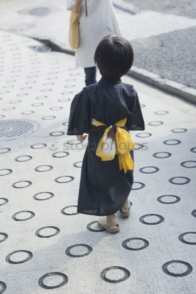 Similar – Image, Stock Photo elegantly dressed lady with black coat, red hat, red scarf and red pumps walks on a large square with concrete and patterned floor