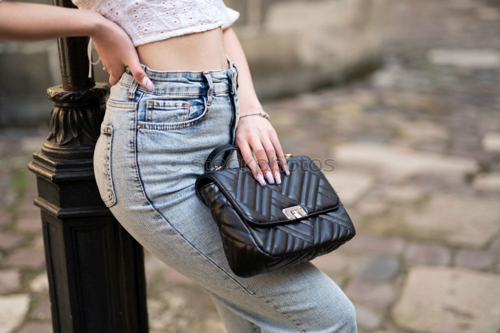 Similar – Image, Stock Photo Back view rear view of a woman holding shopping bags while wearing cool style cloths. Jeans and a top. Shopping street. Changing and buying gifts concept.