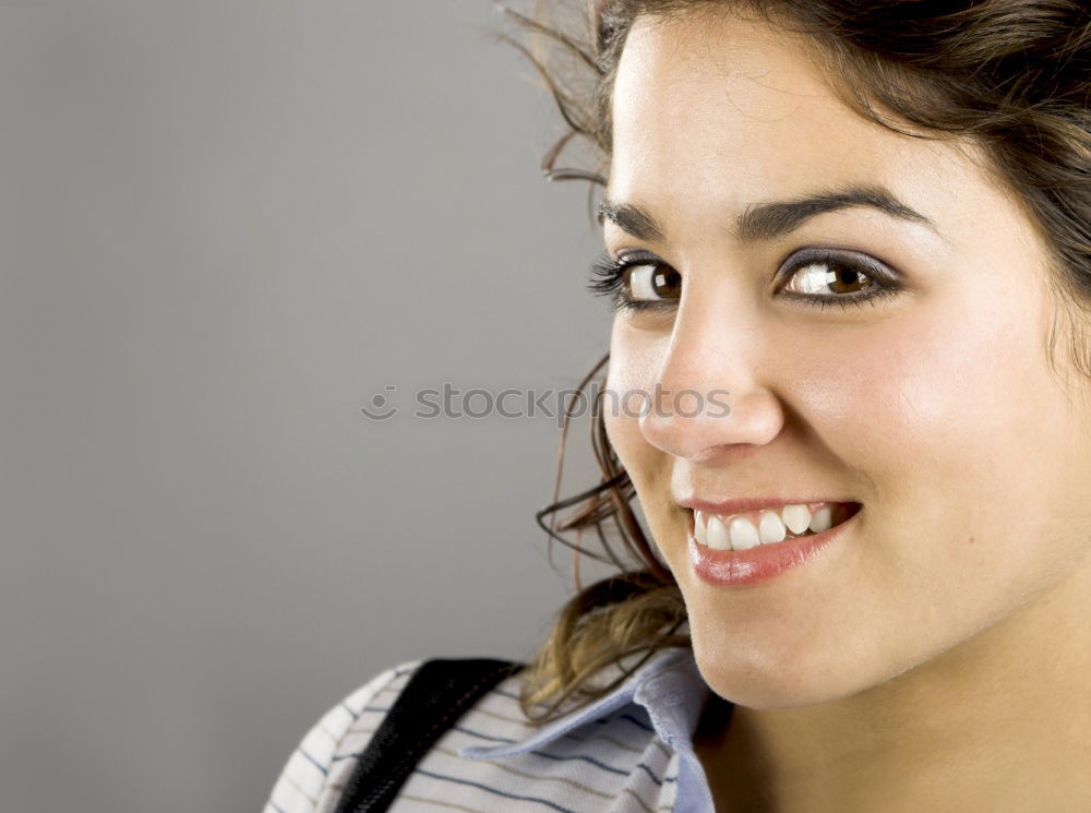 Similar – Close portrait of beautiful young woman with green eyes smiling at camera