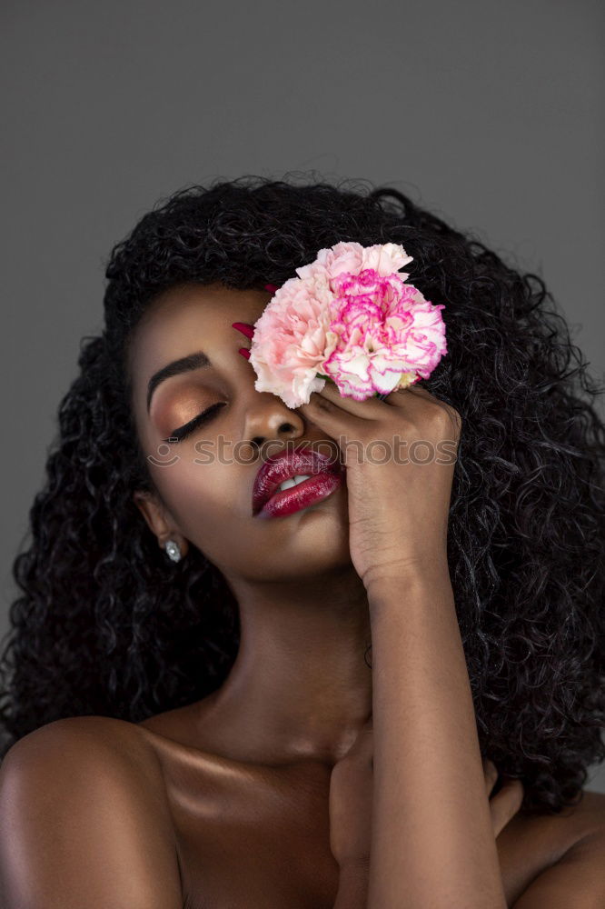 Similar – Thoughtful happy young black woman surrounded by flowers