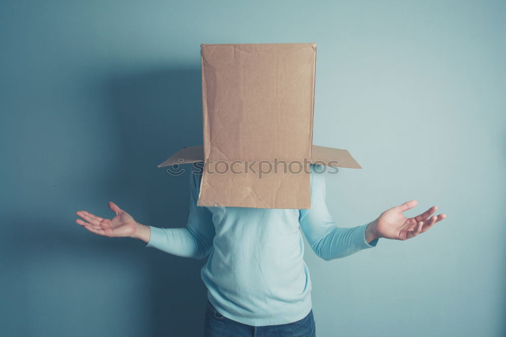 Similar – Person with paper bag on head pointing at camera