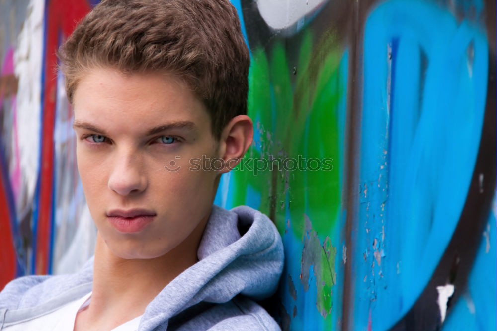 Similar – Portrait of a teenager with hoodie, in front of a red brick wall