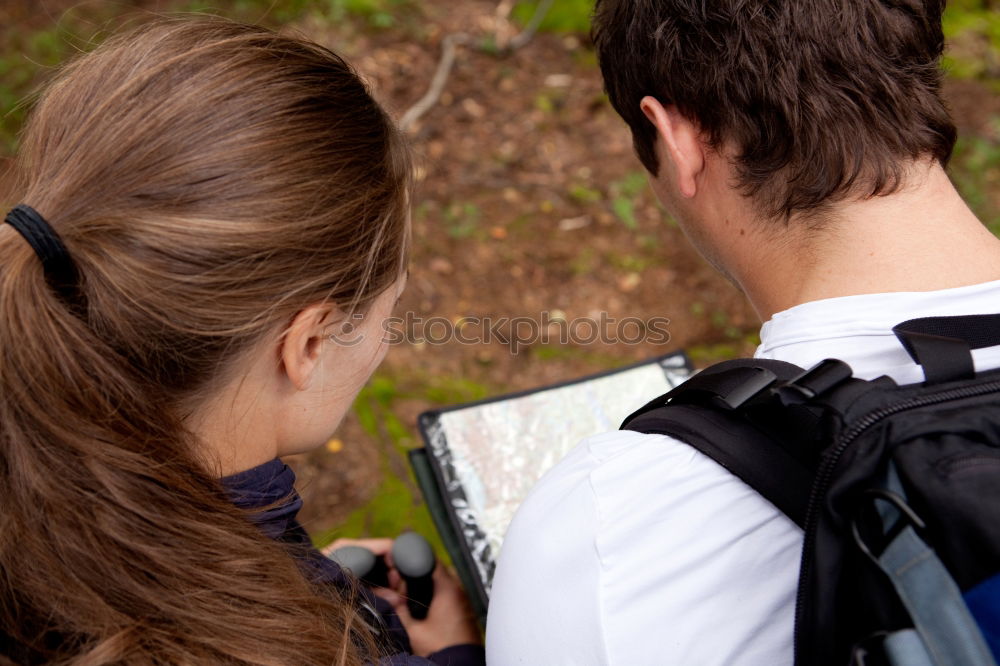 Similar – Image, Stock Photo Couple doing trekking sitting looking mobile and map