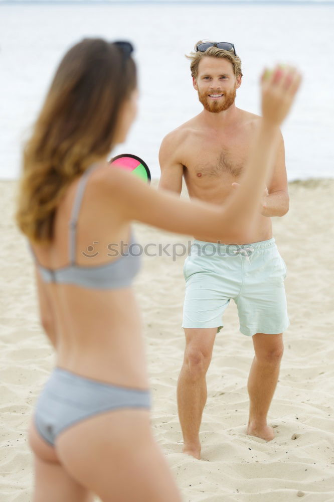 Happy young family of three at the beach