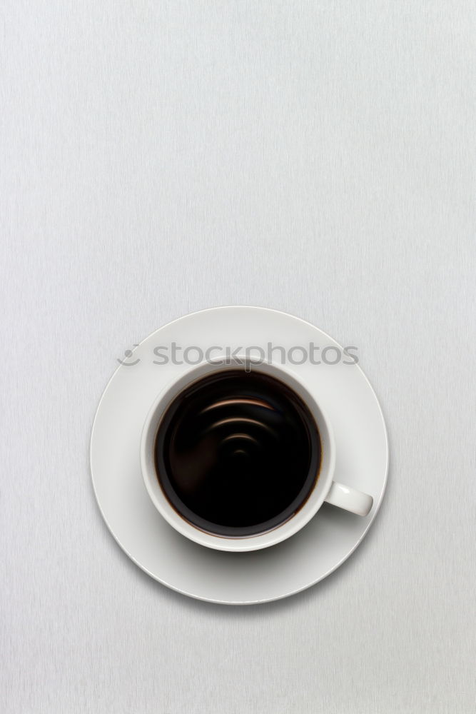 Similar – Image, Stock Photo Overhead view of a cup of black espresso coffee and a freshly baked croissant for breakfast. High angle close up