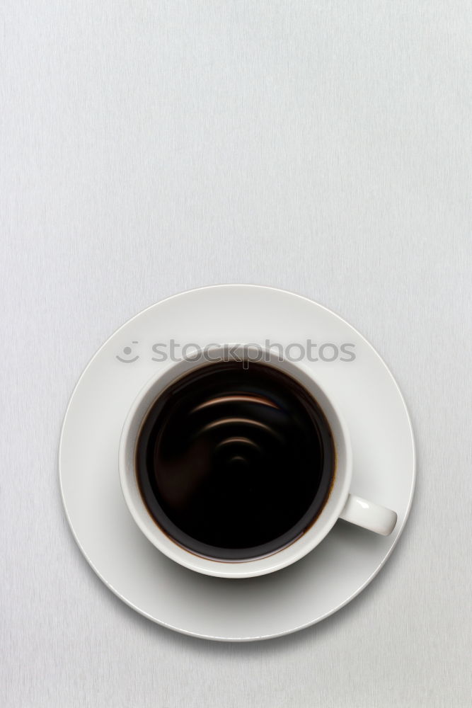 Similar – Image, Stock Photo Overhead view of a cup of black espresso coffee and a freshly baked croissant for breakfast. High angle close up