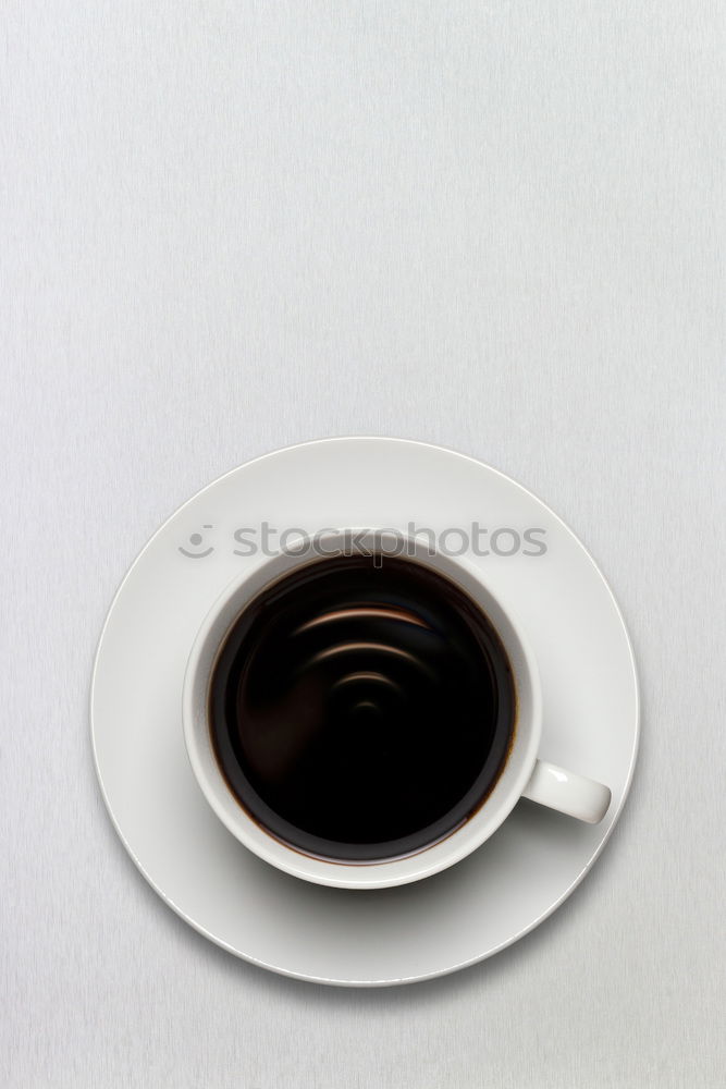 Similar – Image, Stock Photo Overhead view of a cup of black espresso coffee and a freshly baked croissant for breakfast. High angle close up