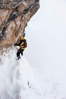 Similar – Female climber in the storm during an extreme winter climb