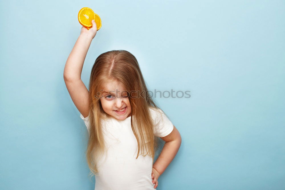 Similar – smiling baby with an orange on blue background