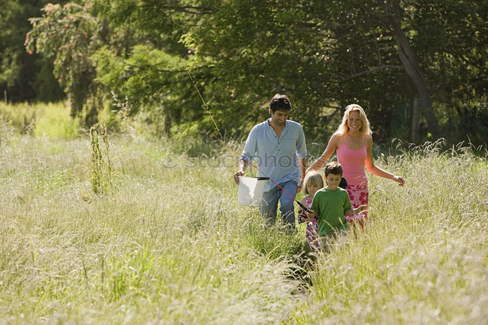 Similar – Grandparents and grandchild jumping on nature path