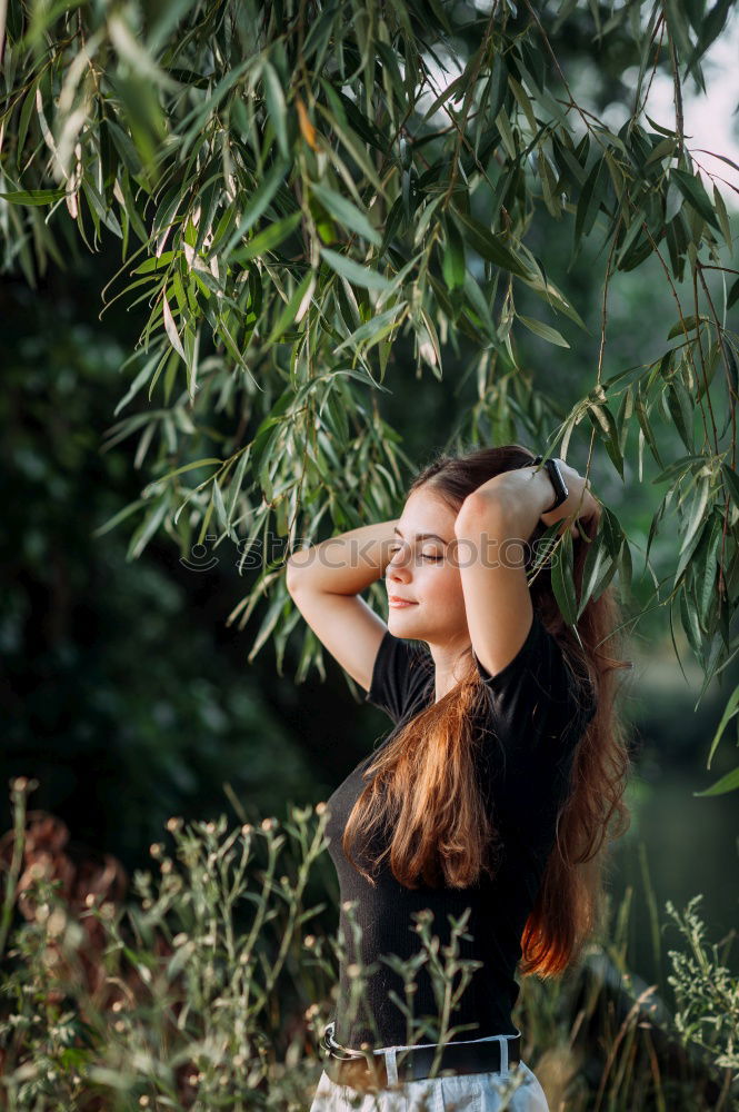 Similar – Young woman hidden behind a plant