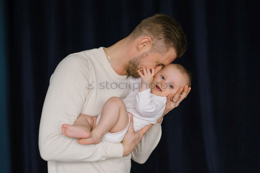 Similar – Image, Stock Photo Couple embracing and looking to their newborn over dark background