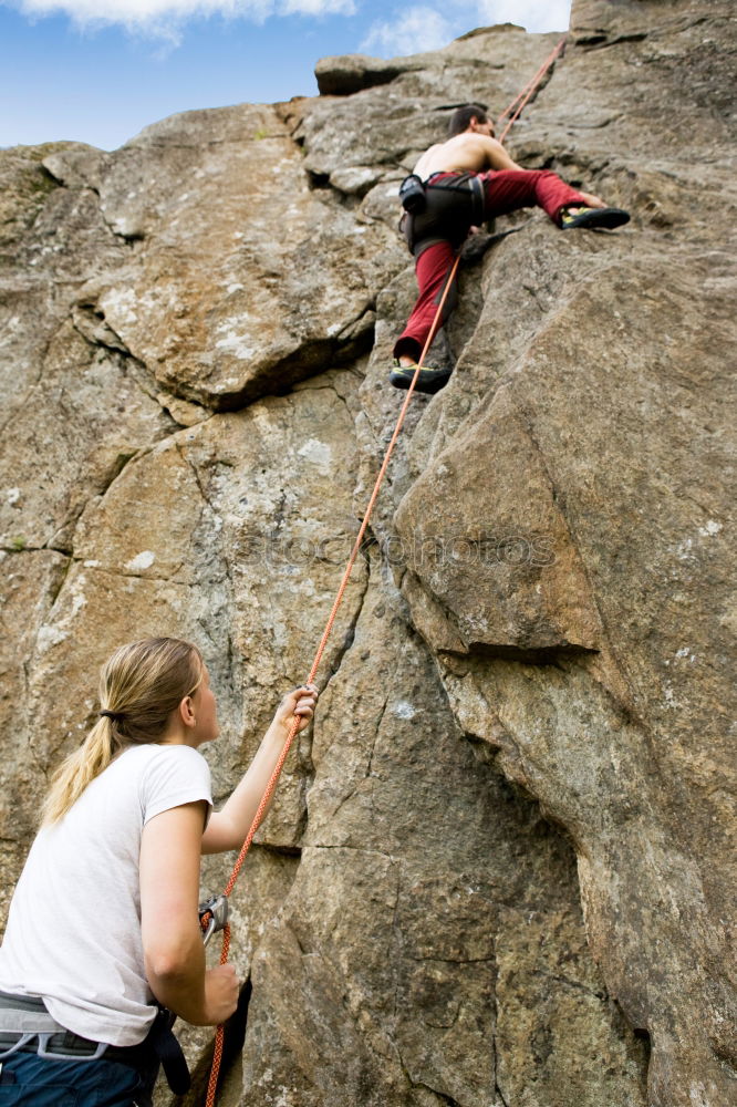 Similar – Rock climbing team reaching the summit.