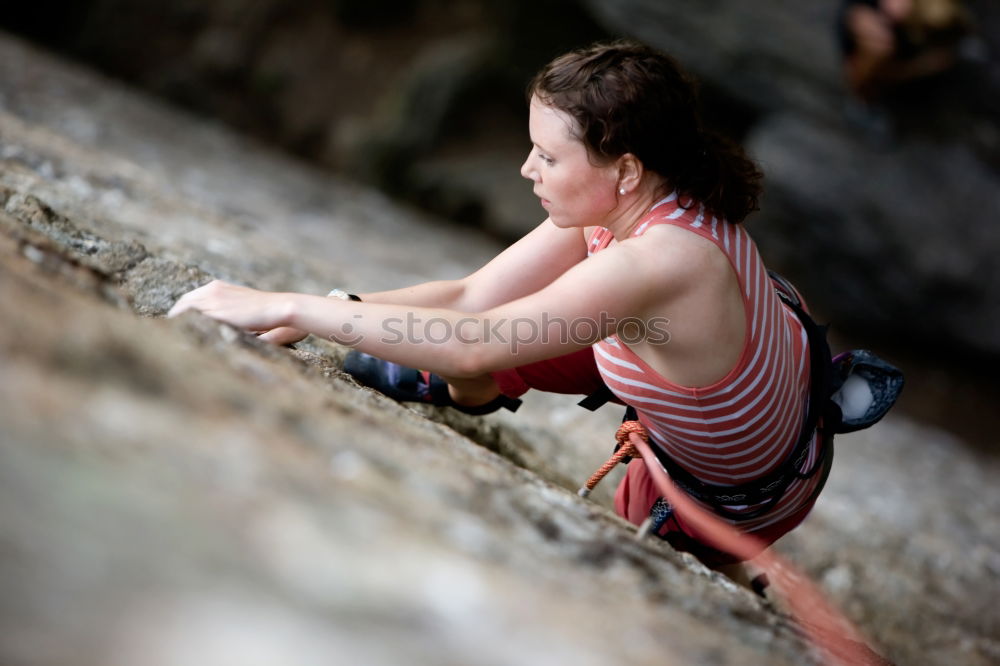 Similar – Young rock climber woman climbing the rock wall