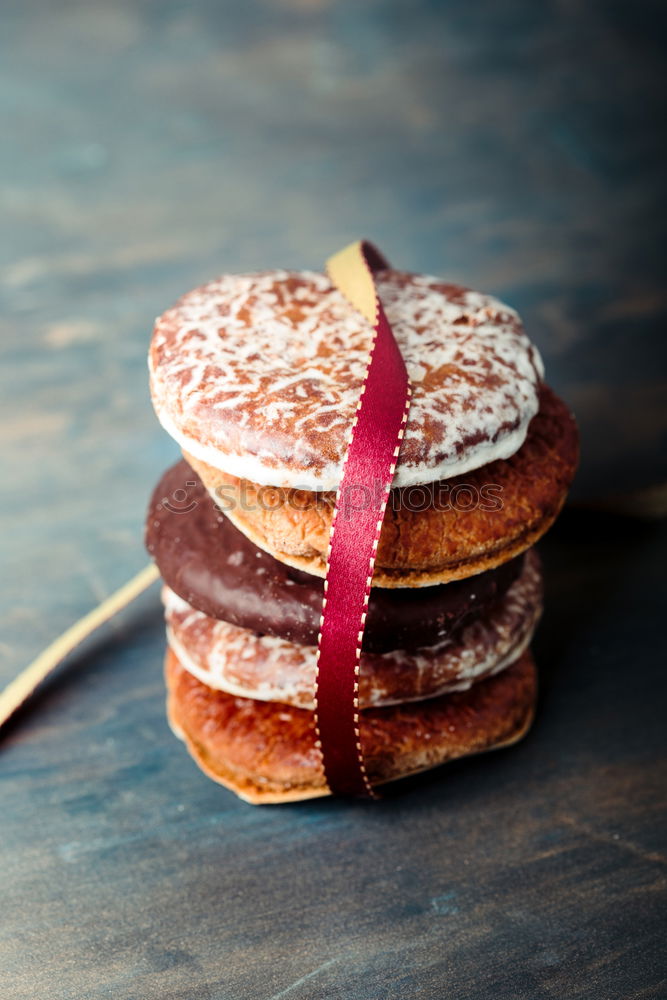 Similar – Image, Stock Photo A few gingerbread cookies wrapped in red ribbon Happy Christmas