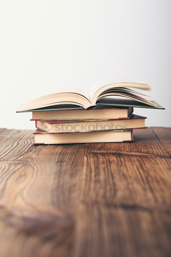 Similar – Image, Stock Photo Woman turning pages of book on table in antique bookstore