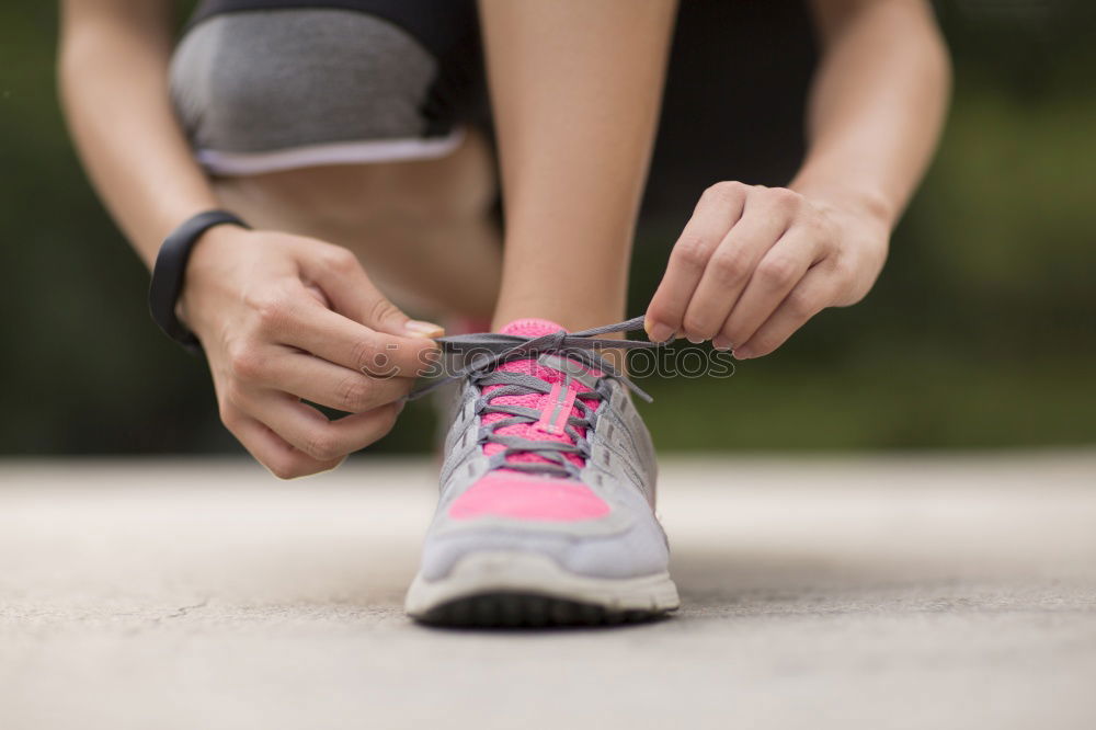 Similar – Image, Stock Photo Close-up shot of man tying running shoes with foot on the bench. Getting ready before jogging. Going in for sports, healthy lifestyle