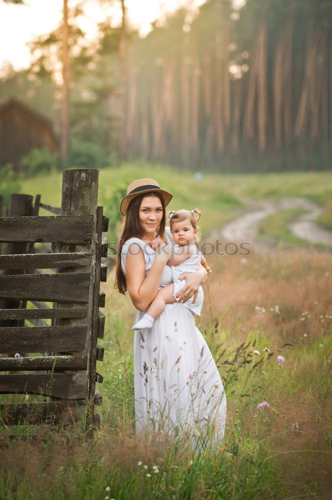 Similar – Woman with child on lawn