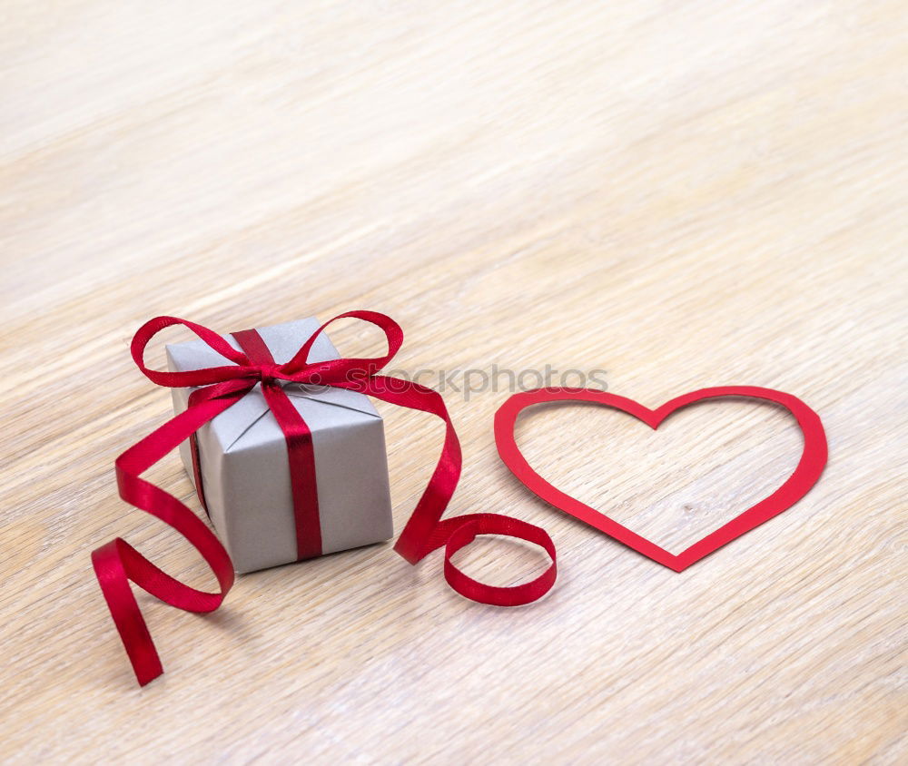 Similar – Gift box wrapped in recycled paper, red bow and tag