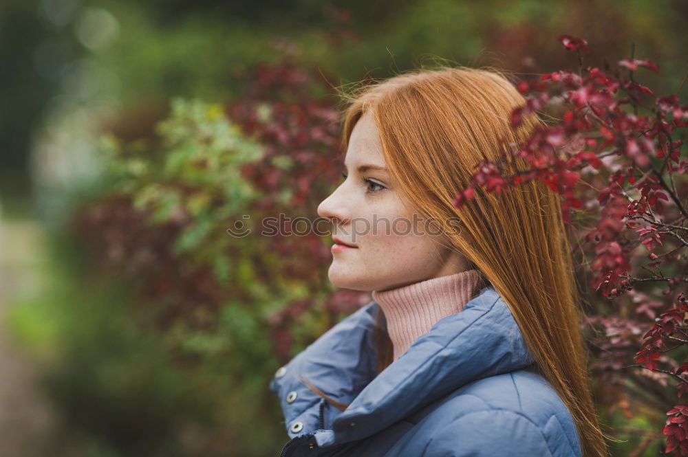 Similar – View through, portrait of young woman in dense vegetation