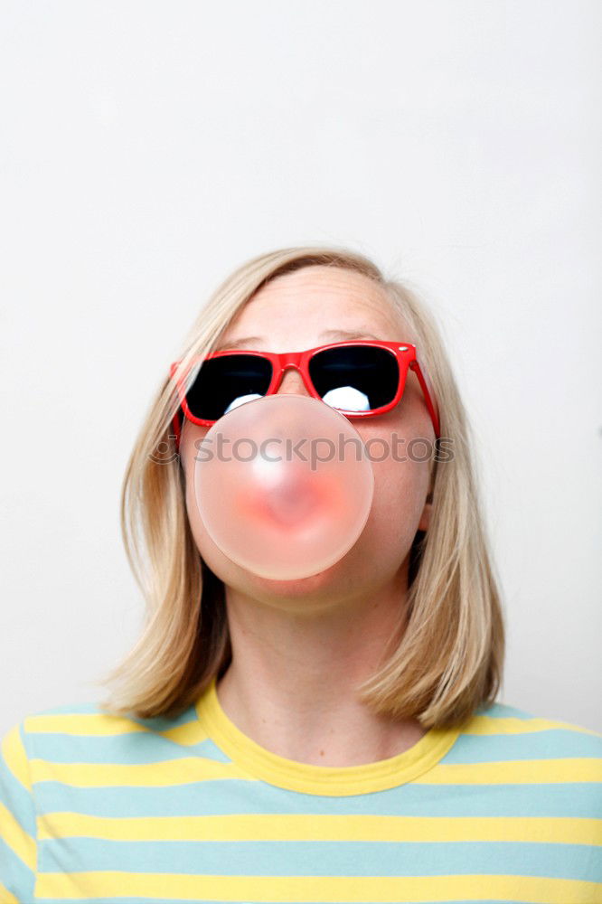 Similar – Young blonde woman biting a lollipop