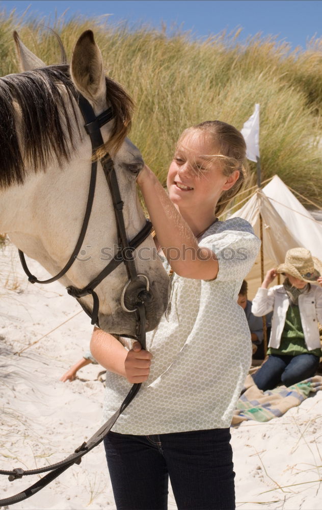 Similar – Young beautiful girl with white horse in forest. Woman horseback rider in boho style. Summertime nature scene.