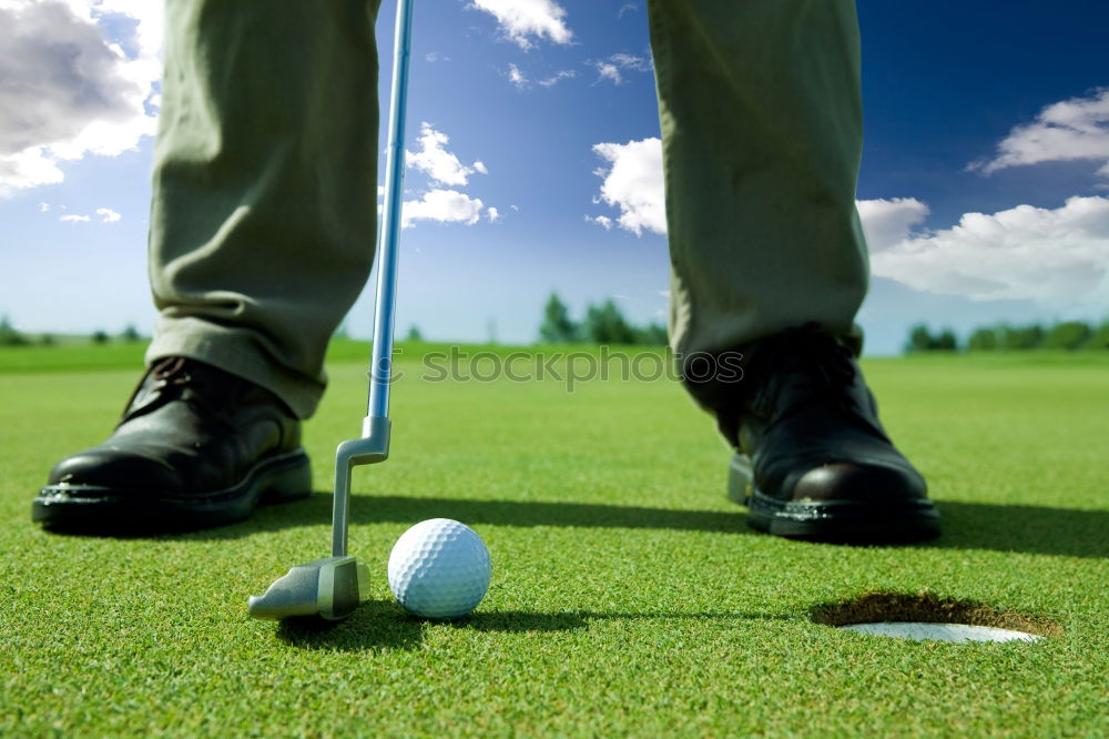 Similar – Golfer performs a golf shot from the fairway